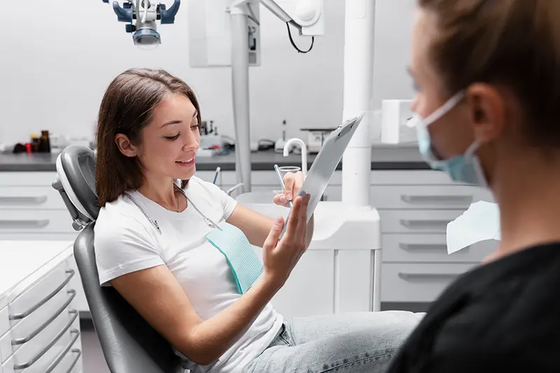 A patient completing a written sleep-apnea risk screening form before her dental appointment
