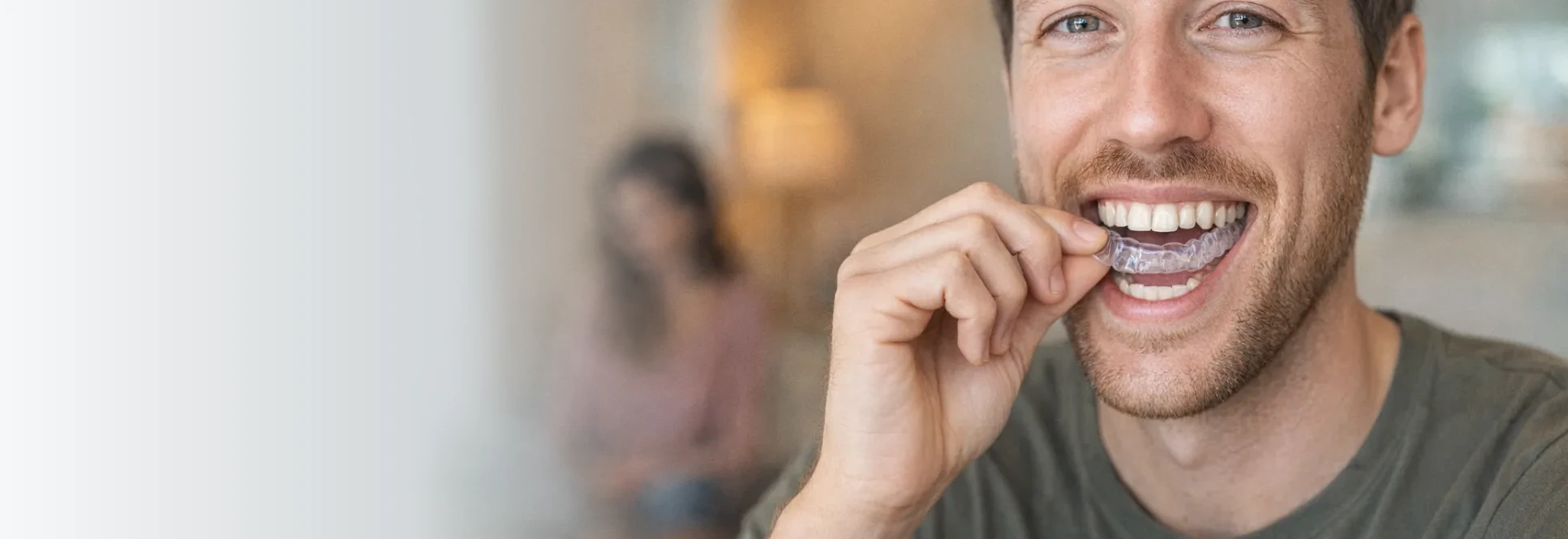 A patient inserting a custom oral appliance designed to protect the TMJ and to advance the mandible for airway support